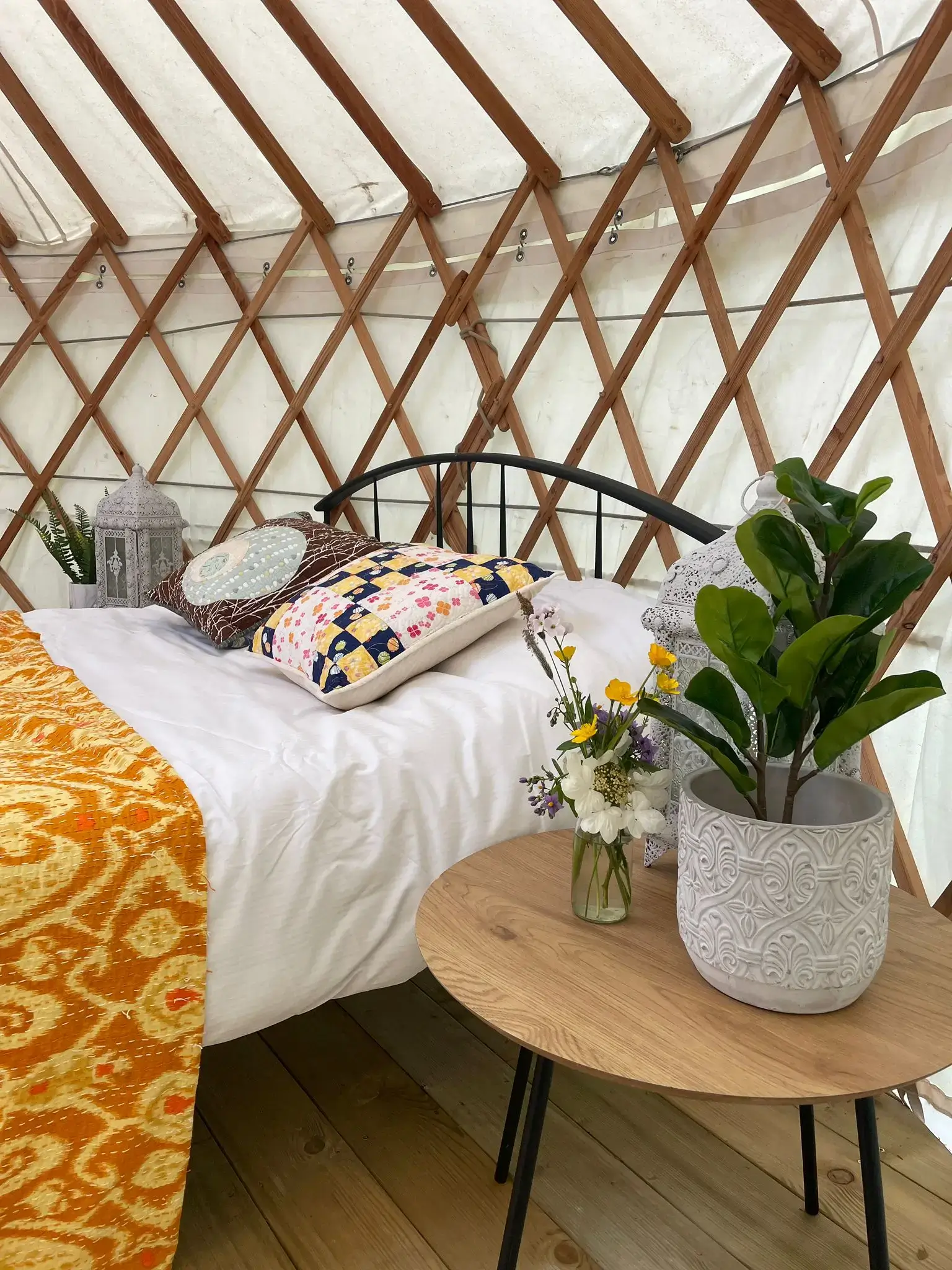 Yurt at the munny trail. Bed and side table and flower in the vase.